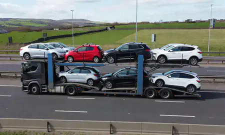 Multi-level car carrier on the motorway to Bolton, Greater Manchester, United Kingdom