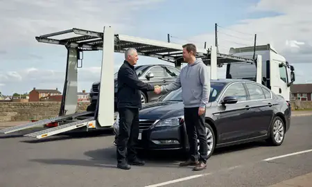 Vehicle owner beside their delivered car in Bolton, Greater Manchester, United Kingdom