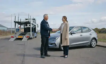 Vehicle owner beside their delivered car in Chadderton, Greater Manchester, United Kingdom