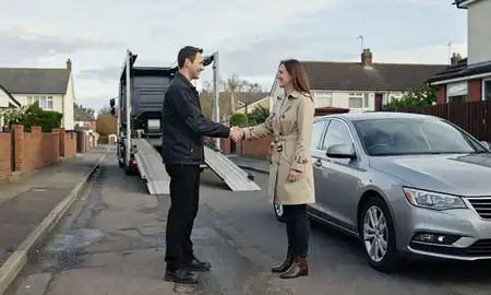 Vehicle owner beside their delivered car in Denton, Greater Manchester, United Kingdom