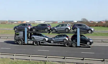 Multi-level car carrier on the motorway to Middleton, Greater Manchester, United Kingdom