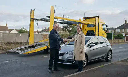 Vehicle owner beside their delivered car in Middleton, Greater Manchester, United Kingdom