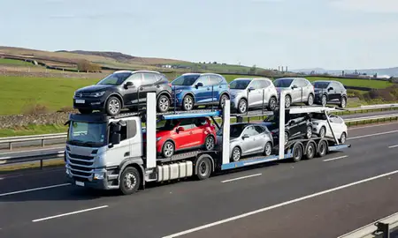 Multi-level car carrier on the motorway to Oldham, Greater Manchester, United Kingdom