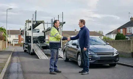 Vehicle owner beside their delivered car in Rochdale, Greater Manchester, United Kingdom