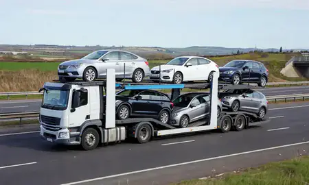Multi-level car carrier on the motorway to Sale, Greater Manchester, United Kingdom
