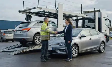 Vehicle owner beside their delivered car in Salford, Greater Manchester, United Kingdom