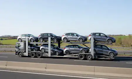 Multi-level car carrier on the motorway to Stockport, Greater Manchester, United Kingdom