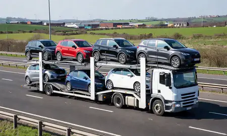Multi-level car carrier on the motorway to Wigan, Greater Manchester, United Kingdom