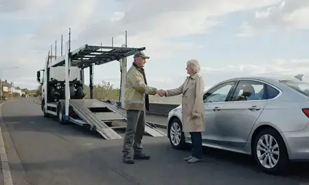 Vehicle owner beside their delivered car in Newport, Gwent, United Kingdom