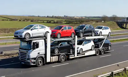 Multi-level car carrier on the motorway to Aldershot, Hampshire, United Kingdom