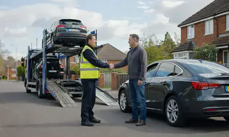 Vehicle owner beside their delivered car in Basingstoke, Hampshire, United Kingdom