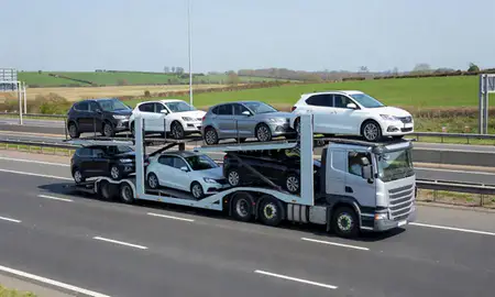 Multi-level car carrier on the motorway to Fareham, Hampshire, United Kingdom