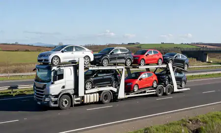 Multi-level car carrier on the motorway to Farnborough, Hampshire, United Kingdom