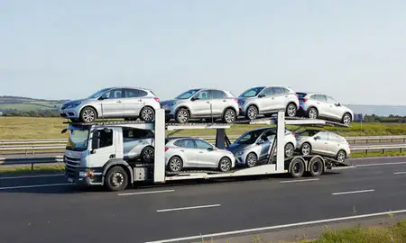 Multi-level car carrier on the motorway to Gosport, Hampshire, United Kingdom
