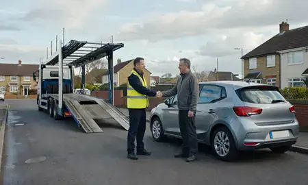 Vehicle owner beside their delivered car in Gosport, Hampshire, United Kingdom