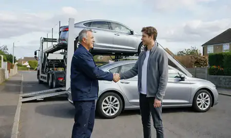 Vehicle owner beside their delivered car in Horndean, Hampshire, United Kingdom