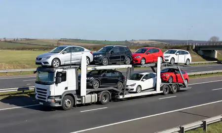 Multi-level car carrier on the motorway to Portsmouth, Hampshire, United Kingdom