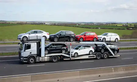 Multi-level car carrier on the motorway to Southampton, Hampshire, United Kingdom