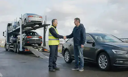 Vehicle owner beside their delivered car in Southampton, Hampshire, United Kingdom