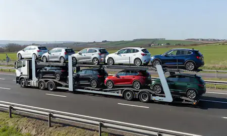 Multi-level car carrier on the motorway to Winchester, Hampshire, United Kingdom