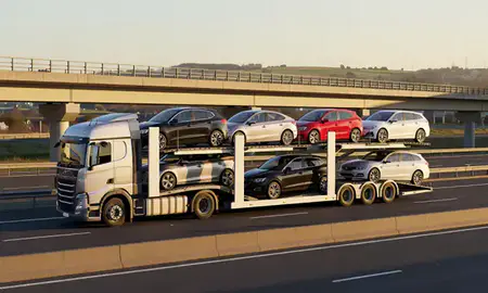 Car transporter with the Hertfordshire, United Kingdom skyline behind it