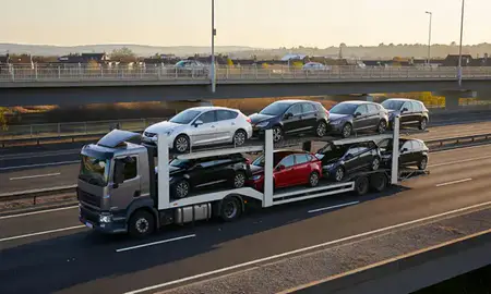 Car transporter with the Bishop's Stortford, Hertfordshire, United Kingdom skyline behind it
