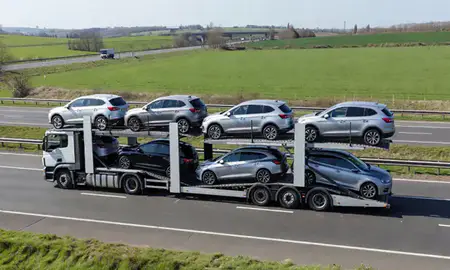 Multi-level car carrier on the motorway to Hitchin, Hertfordshire, United Kingdom