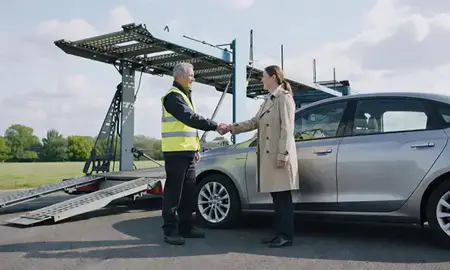 Vehicle owner beside their delivered car in Hoddesdon, Hertfordshire, United Kingdom