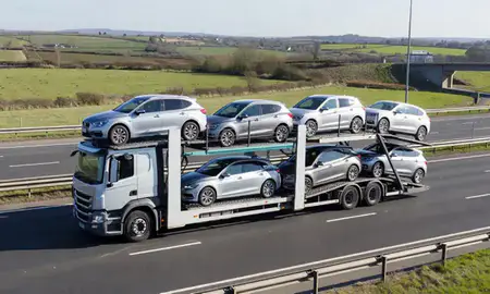 Multi-level car carrier on the motorway to St Albans, Hertfordshire, United Kingdom
