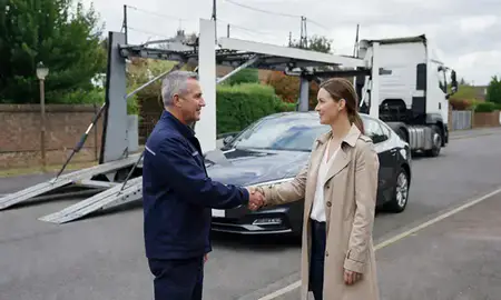 Vehicle owner beside their delivered car in St Albans, Hertfordshire, United Kingdom