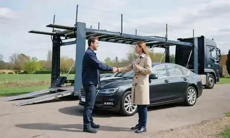 Vehicle owner beside their delivered car in Welwyn Garden City, Hertfordshire, United Kingdom