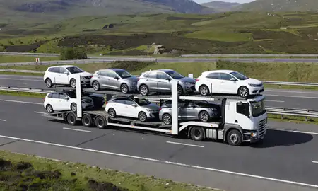 Multi-level car carrier on the motorway to Highland, United Kingdom