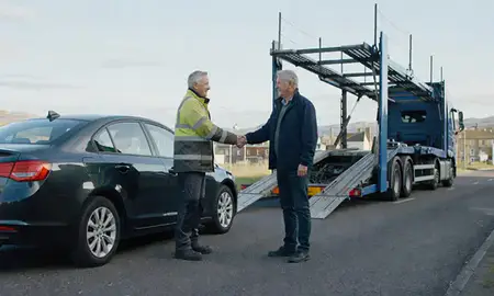 Vehicle owner beside their delivered car in Inverness, Highland, United Kingdom