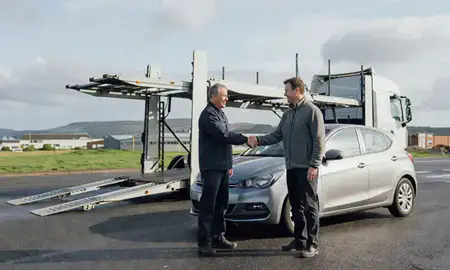 Vehicle owner beside their delivered car in Inverclyde, United Kingdom