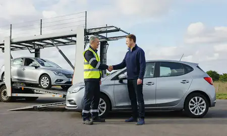 Vehicle owner beside their delivered car in Chatham, Kent, United Kingdom