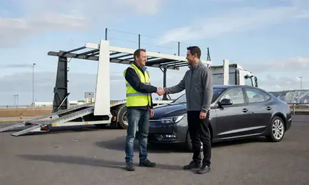 Vehicle owner beside their delivered car in Dover, Kent, United Kingdom