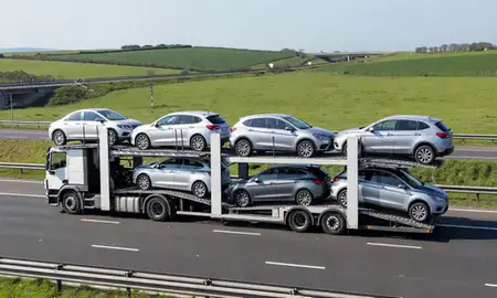 Multi-level car carrier on the motorway to Folkestone, Kent, United Kingdom