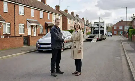 Vehicle owner beside their delivered car in Gillingham, Kent, United Kingdom