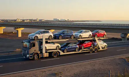 Car transporter with the Margate, Kent, United Kingdom skyline behind it