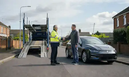 Vehicle owner beside their delivered car in Accrington, Lancashire, United Kingdom
