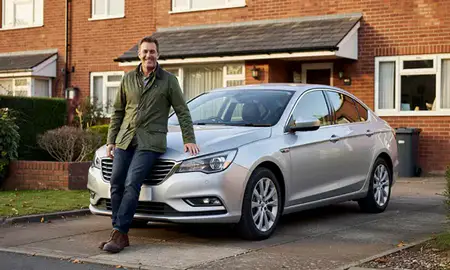 Customer with their delivered car in Blackburn, Lancashire, United Kingdom