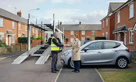 Vehicle owner beside their delivered car in Leyland, Lancashire, United Kingdom