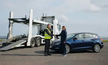 Vehicle owner beside their delivered car in Merseyside, United Kingdom