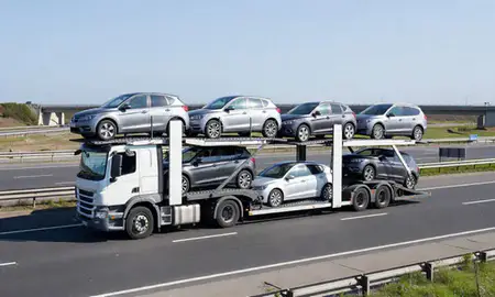 Multi-level car carrier on the motorway to Birkenhead, Merseyside, United Kingdom