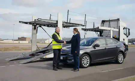 Vehicle owner beside their delivered car in Birkenhead, Merseyside, United Kingdom