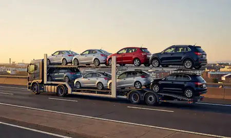 Car transporter with the Bootle, Merseyside, United Kingdom skyline behind it