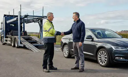 Vehicle owner beside their delivered car in Crosby, Merseyside, United Kingdom