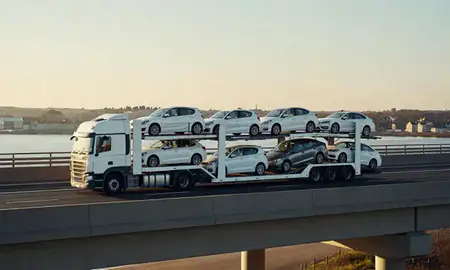 Car transporter with the Crosby, Merseyside, United Kingdom skyline behind it