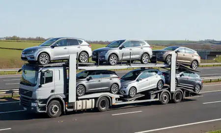 Multi-level car carrier on the motorway to Prescot, Merseyside, United Kingdom