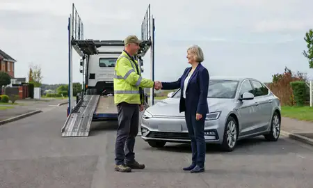 Vehicle owner beside their delivered car in Southport, Merseyside, United Kingdom